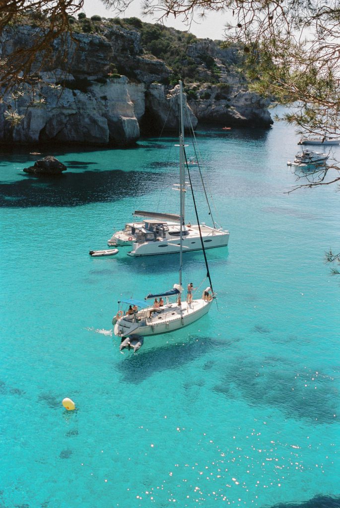 A private boat in a cala in menorca with turquoise water