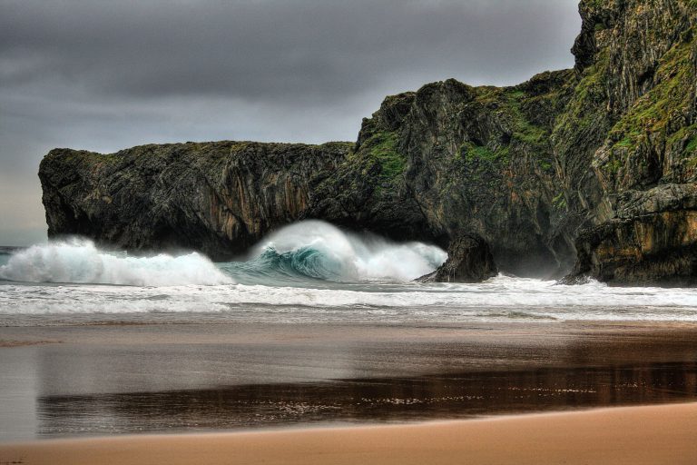 Beach scene with rolling waves, Llanes, Basque Country, Spain